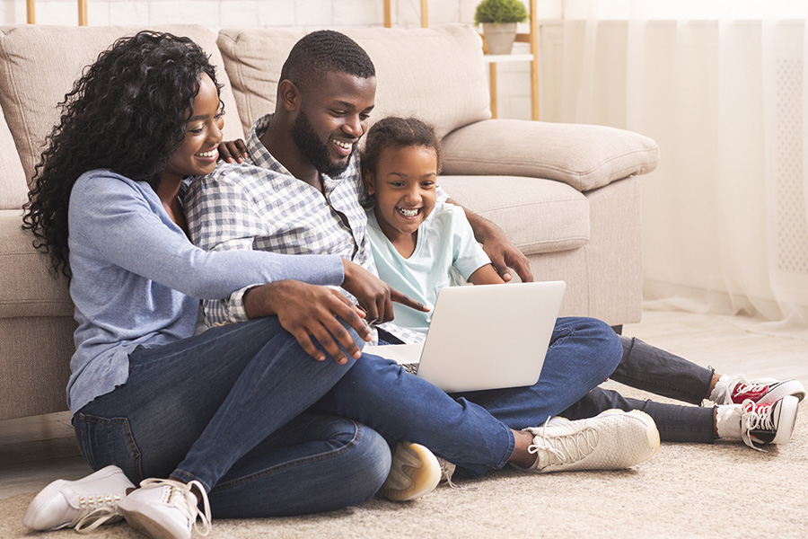 Personal Insurance - Family of Three Using Laptop Together at Home
